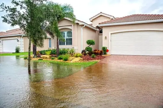 King Tides in Naples and Southwest Florida: Is Your Home and Car Covered? 1 Standing water covering part of a residential driveway beside a home